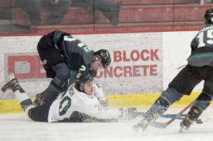 Kenai River Brown Bears forward Ryan Finch battles Minnesota Wilderness defenseman Severi Sulonen and forward Cole Gordon for the puck Friday, March 18, 2022, at the Soldotna Regional Sports Complex in Soldotna, Alaska. (Photo by Jeff Helminiak/Peninsula Clarion)