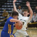 Iukah Kalugin defends against Metlakatla's Cameron Gaube during the 2A state basketball championship game at the Alaska Airlines Center in Anchorage, Alaska on Saturday, March 19, 2022. (Camille Botello/Peninsula Clarion)