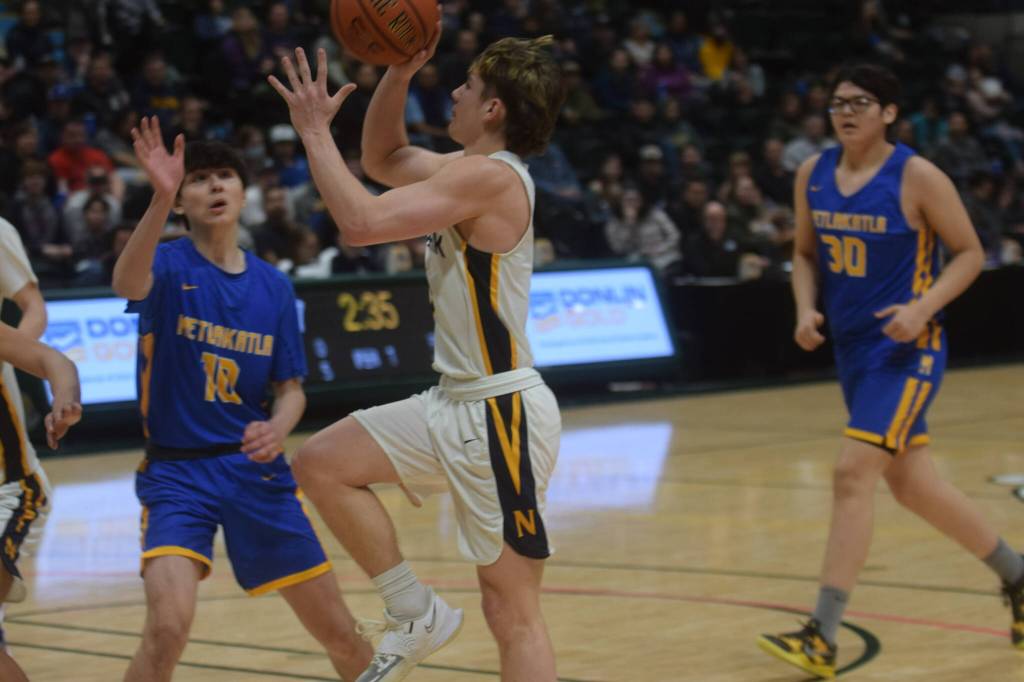 Landon Colburn takes a shot against Metlakatla during the 2A state basketball championship game at the Alaska Airlines Center in Anchorage, Alaska on Saturday, March 19, 2022. (Camille Botello/Peninsula Clarion)