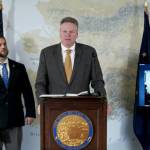 Adam Crum (left), Gov. Mike Dunleavy and Alaska Sen. Peter Micciche (on screen) discuss the move to split the Department of Health and Social Services into two separate agencies, on Monday, March 21, 2022, in Juneau, Alaska. (Screenshot)