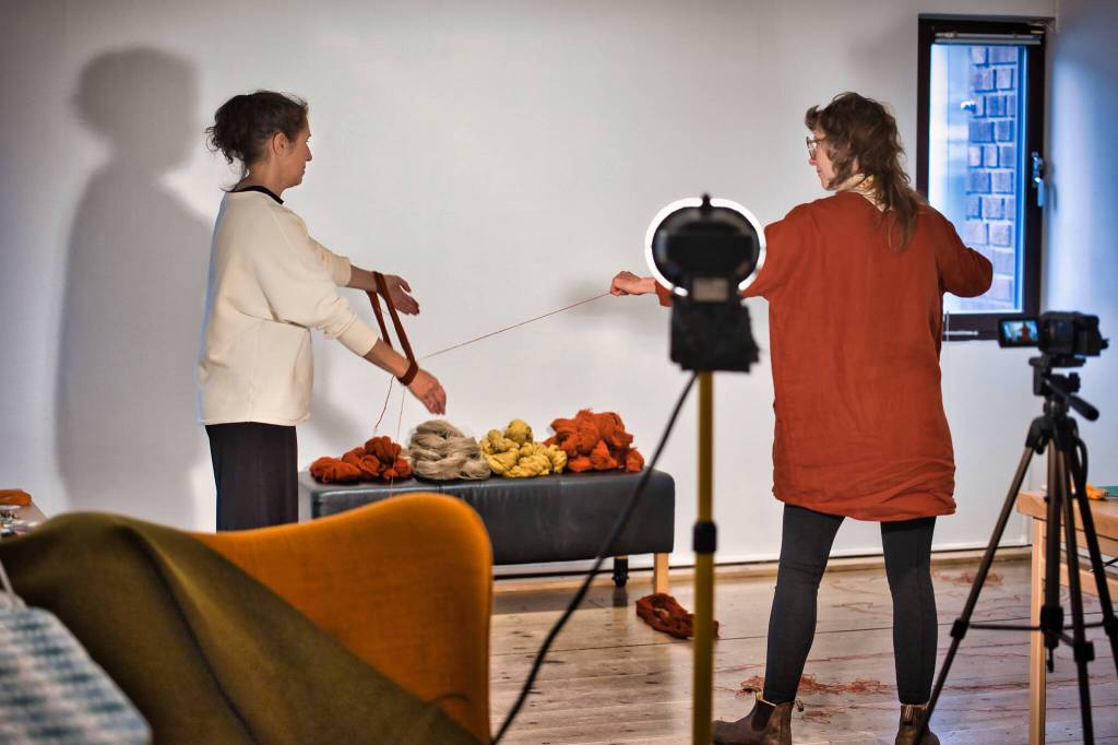 Bunnell Street Arts Center visiting artist-in-residence Berith Stennabb, left, and Homer artist Mandy Bernard, record the collaborative process of unraveling wool donated by a regional weaving collective in Sweden during Bernards visit to the Konstmuseet, Skövde Kulturhus in Skövde, Sweden in November and December 2021. (Photo by Hugo Andersson)