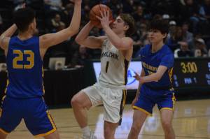 Landon Colburn takes a shot against Metlakatlas Shayne Anderson during the 2A state basketball championship game at the Alaska Airlines Center in Anchorage, Alaska on Saturday, March 19, 2022. (Camille Botello/Peninsula Clarion)