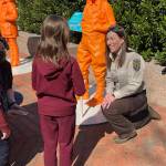 Kris Inman speaks to a young girl, age 7, who hopes to be a veterinarian at the #IfThenSheCan-The Exhibit showcasing the Smithsonian Institute Womenճ Future Month. (Photo by Kim Spectre)