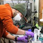 This Feb. 17, 2022, photo shows Roman Pohorsky, a doctorate student at the EPFL, a science and technology institution in Switzerland, working with lab equipment in Fairbanks, Alaska. Over seven weeks this winter, nearly 50 scientists from the continental U.S. and Europe descended on Fairbanks to study the sources of air pollution, how they interact in the citys cold and dark climate and to come up with a list of best practices for others across the circumpolar north struggling to get a breath of fresh air. (AP Photo/Mark Thiessen)
