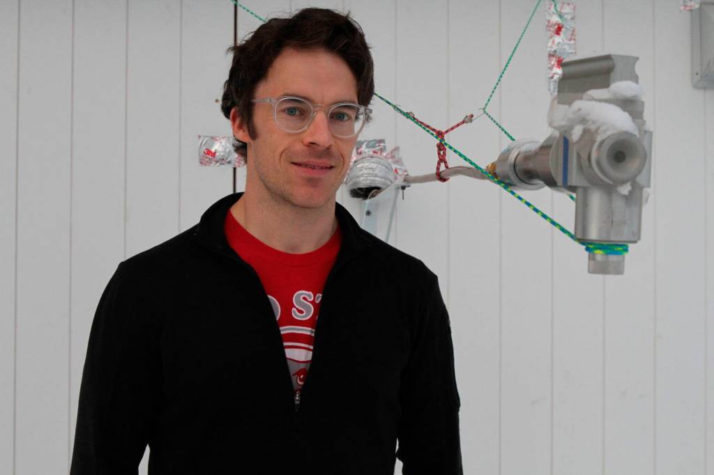 This Feb. 16, 2022, photo shows Ellis Robinson, a a post-doctoral researcher at Johns Hopkins University in Baltimore, with an air intake instrument that helps measure air pollution at a home in Fairbanks, Alaska. Over seven weeks this winter, nearly 50 scientists from the continental U.S. and Europe descended on Fairbanks to study the sources of air pollution, how they interact in the citys cold and dark climate and to come up with a list of best practices for others across the circumpolar north struggling to get a breath of fresh air. (AP Photo/Mark Thiessen)