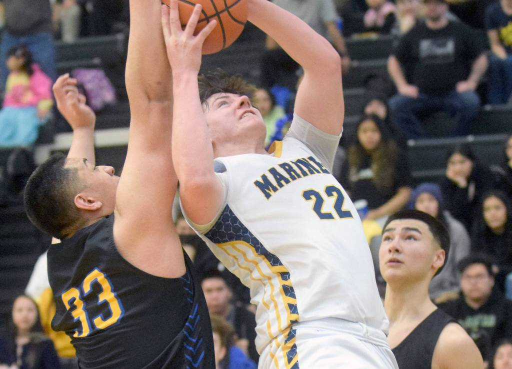 Homers Carter Tennison takes a shot against Barrows Uata Tuifua during the Class 3A boys basketball fourth-place semifinals at the Alaska Airlines Center in Anchorage, Alaska, on Thursday, March 24, 2022. (Camille Botello/Peninsula Clarion)