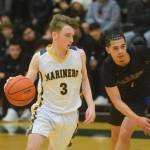 Peyton Edens makes a move toward the basket during the Class 3A boys basketball semi finals at the Alaska Airlines Center in Anchorage, Alaska on Thursday, March 24, 2022. (Camille Botello/Peninsula Clarion)