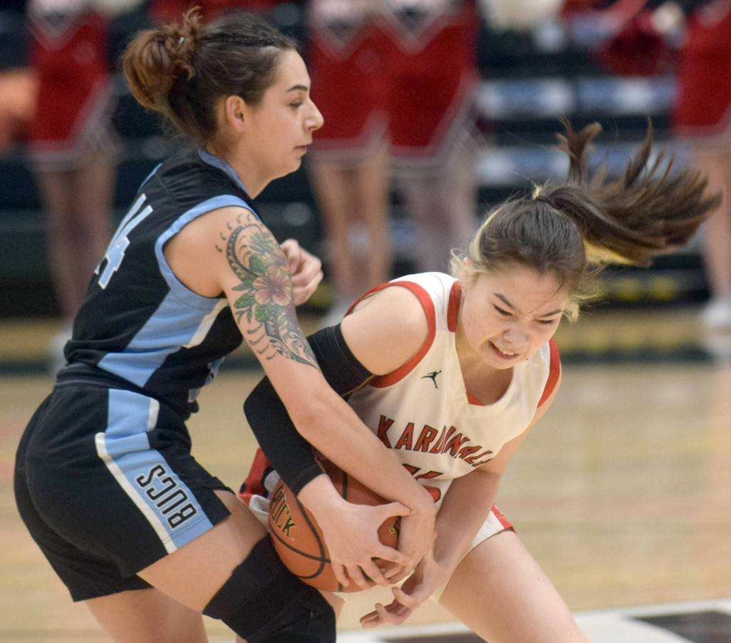 Kenai Central's Malerie Nunn fights for the ball against Valdez defender Kylie Gilbert during the Class 3A girls basketball fourth-place semifinals at the Alaska Airlines Center in Anchorage, Alaska, on Thursday, March 24, 2022. (Camille Botello/Peninsula Clarion)