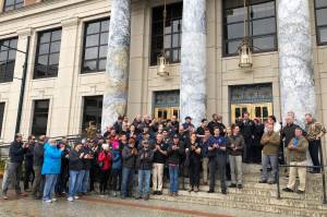 State and municipal public safety employees gathered on the steps of the Alaska State Captiol on Thursday, March 31, 2022, to urge senators to act on a bill to rework the states pension system for police, fire fighters and other public safety employees. (Peter Segall / Juneau Empire)