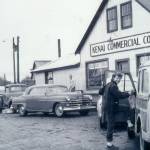Better Homes & Gardens article photo, 1955 
Rusty Lancashire, who befriended her neighbor, Miriam Mathers, climbs into her vehicle in front of the Kenai Commercial Company store in Kenai.