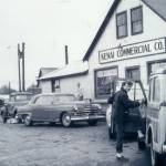 Rusty Lancashire, who befriended her neighbor, Miriam Mathers, climbs into her vehicle in front of the Kenai Commercial Company store in Kenai. (Better Homes & Gardens article photo, 1955)