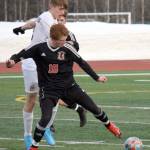 Kenai Central's Wade James and Grace Christian's Caden Nanninga battle for the ball Friday, April 1, 2022, at Kenai Central High School in Kenai, Alaska. (Photo by Jeff Helminiak/Peninsula Clarion)