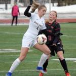Grace Christian's Sophia Coverdell and Kenai Central's Kylie Verkuilen battle for the ball Friday, April 1, 2022, at Kenai Central high School in Kenai, Alaska. (Photo by Jeff Helminiak/Peninsula Clarion)
