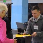 A participant seeks probation services at the Kenai Peninsula Re-Entry Coalition simulation at the Old Carrs Mall in Kenai, Alaska, on Saturday, April 2, 2022. The event was intended to give community members an understanding of the challenges faced by those leaving incarceration. (Camille Botello/Peninsula Clarion)