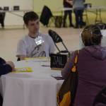 Participants wait in a mock jail at the Kenai Peninsula Re-Entry Coalition simulation at the Old Carrs Mall in Kenai, Alaska, on Saturday, April 2, 2022. The event was intended to give community members an understanding of the challenges faced by those leaving incarceration. (Camille Botello/Peninsula Clarion)