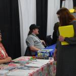 Community members participate in the Kenai Peninsula Job and Career Fair at the Soldotna Regional Sports Complex on Thursday, April 7, 2022, in Soldotna, Alaska. (Camille Botello/Peninsula Clarion)