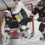 Kenai River Brown Bears forward Nick Stevens runs into Minnesota Magicians goalie Josh Langford on Saturday, April 9, 2022, at the Soldotna Regional Sports Complex in Soldotna, Alaska. (Photo by Jeff Helminiak/Peninsula Clarion)