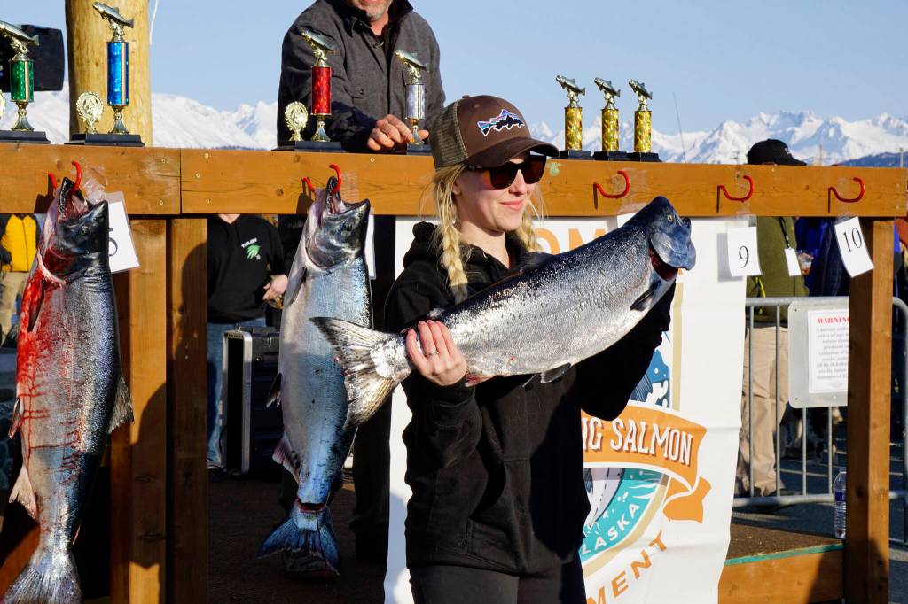 Molly Wilmer holds the 17.9-pound winter king salmon she caught in the 28th annual Homer Winter King Salmon Tourament on Sunday, April 10, 2022, in Kachemak Bay, Homer, Alaska. Wilmer took seventh place and was the top woman angler. (Photo by Michael Armstrong/Homer News)