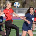 Kenai Central's Cali Holmes tries to clear the ball from Soldotna's Caleigh Glassmaker and Caylee Uribe-Koivisto on Thursday, April 14, 2022, at Soldotna High School in Soldotna, Alaska. (Photo by Jeff Helminiak/Peninsula Clarion)