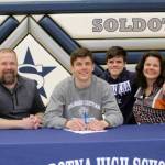 Nate Johnson signs his National Letter of Intent on Friday, April 22, 2022, at Soldotna High School in Soldotna, Alaska. From left to right are Nate's father, Eric; Nate; Nate's brother, Wesley; and Nate's mother, Meghan. (Photo provided)