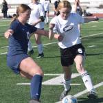 Soldotnas Sadie Lane and Nikiskis Dani Thies battle for the ball Wednesday, April 27, 2022, at Justin Maile Field at Soldotna High School in Soldotna, Alaska. (Photo by Jeff Helminiak/Peninsula Clarion)