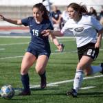 Soldotnas Katharine Bramante and Nikiskis Mady Stichal battle for the ball Wednesday, April 27, 2022, at Justin Maile Field at Soldotna High School in Soldotna, Alaska. (Photo by Jeff Helminiak/Peninsula Clarion)