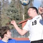 Nikiski's Truit McCaughey heads the ball over Soldotna's Silas Larsen on Wednesday, April 27, 2022, at Justin Maile Field at Soldotna High School in Soldotna, Alaska. (Photo by Jeff Helminiak/Peninsula Clarion)