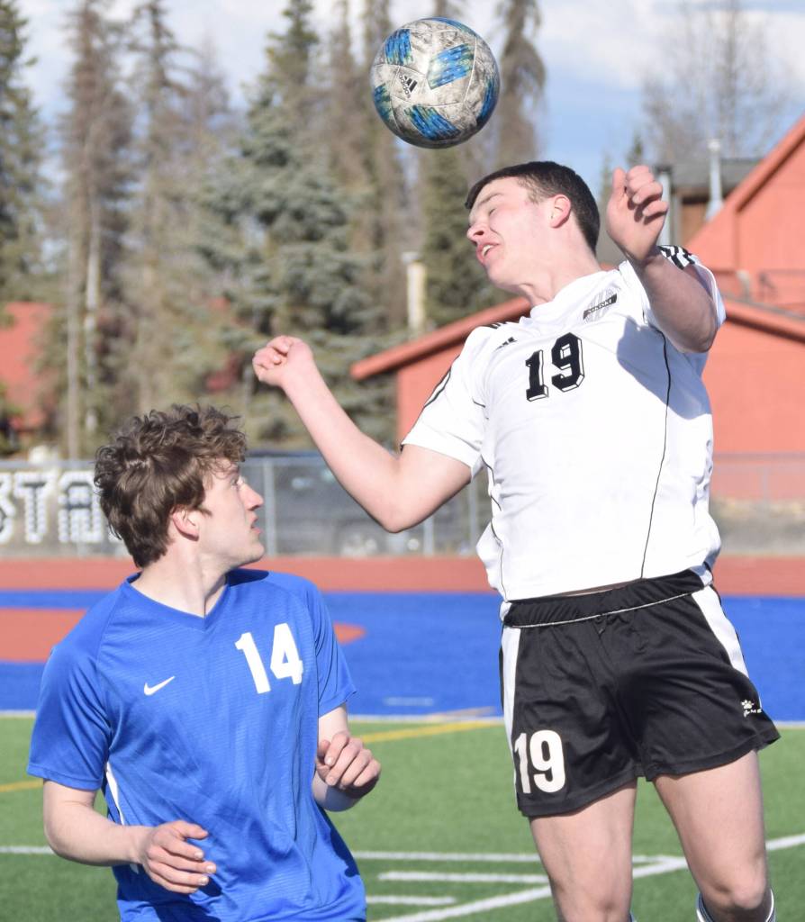 Nikiskis Truit McCaughey heads the ball over Soldotnas Silas Larsen on Wednesday, April 27, 2022, at Justin Maile Field at Soldotna High School in Soldotna, Alaska. (Photo by Jeff Helminiak/Peninsula Clarion)