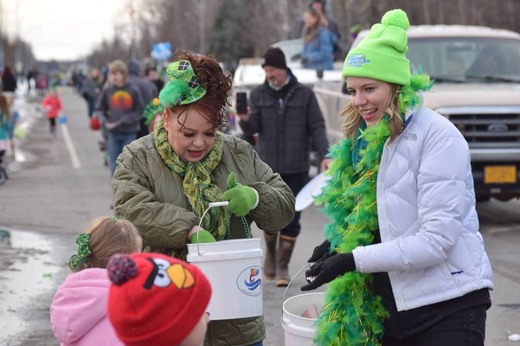 Shanon Davis and Monique Burgin of the Soldotna Chamber of Commerce hand out candy during the Sweeneys St. Patricks Parade in Soldotna on March 17, 2022. (Camille Botello/Peninsula Clarion)