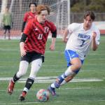 Kenai Centrals Wade James dribbles against Palmers Noah Wilkins on Friday, April 29, 2022, at Kenai Central High School in Kenai, Alaska. (Photo by Jeff Helminiak/Peninsula Clarion)