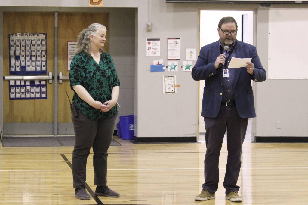 Kenai Peninsula Borough School District Superintendent Clayton Holland, right, speaks at an assembly at Sterling Elementary School honoring Sterling Elementary School Principal Denise Kelly, who was named Alaska Elementary Principal of the Year on Monday, May 2, 2022, in Sterling, Alaska. (Ashlyn OHara/Peninsula Clarion)