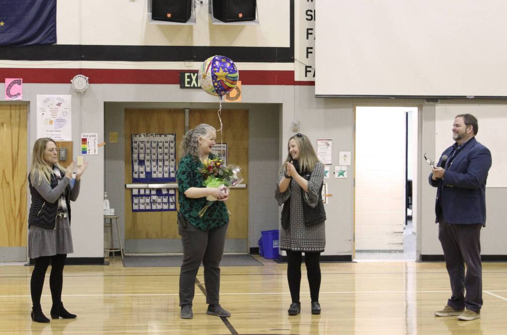 From left: Jennifer Schmitz, Denise Kelly, Jennifer Rinaldi and Clayton Holland attend a surprise assembly at Sterling Elementary School held to celebrate Kelly being named Alaska Elementary Principal of the Year, on Monday, May 2, 2022, in Sterling, Alaska. (Ashlyn OHara/Peninsula Clarion)