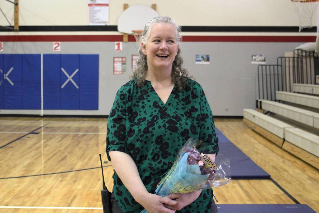 Sterling Elementary School Principal Denise Kelly holds flowers at Sterling Elementary School after a surprise assembly to celebrate her being named Alaska Elementary Principal of the Year, on Monday, May 2, 2022 in Sterling, Alaska. (Ashlyn OHara/Peninsula Clarion)