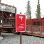 Signage marks the location of a Tesla charging station on Saturday, April 30, 2022, in Soldotna, Alaska. (Ashlyn OHara/Peninsula Clarion)