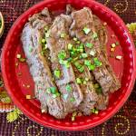 Kalbi ribs can be served with an assortment of side dishes, including white rice, kimchi, roasted garlic cloves, broccoli salad, dumplings and soup. (Photo by Tressa Dale/Peninsula Clarion)