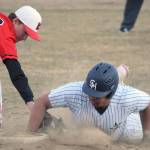 Soldotnas Atticus Gibson slides in safely in front of the tag of Kenai Central first baseman Xander Amend at the Soldotna Little League fields Wednesday, May 4, 2022, in Soldotna, Alaska. (Photo by Jeff Helminiak/Peninsula Clarion)