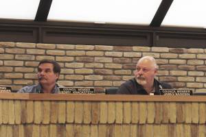 Kenai City Council members Henry Knackstedt, left, and James Baisden participate in a council meeting on Wednesday, May 4, 2022, in Kenai, Alaska. (Ashlyn OHara/Peninsula Clarion)