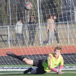 Kenai Central goalie Gavin Langham saves a penalty kick against Dimond on Friday, May 6, 2022, at Ed Hollier Field at Kenai Central High School in Kenai, Alaska. (Photo by Jeff Helminiak/Peninsula Clarion)