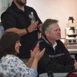 Alaska Department of Health and Social Services Commissioner Adam Crum, Soldotna Senior Center Executive Director Loretta Knudson-Spalding and Alaska Gov. Mike Dunleavy attend a Meals on Wheels event at the Soldotna Senior Center on Friday, May 6, 2022. (Camille Botello/Peninsula Clarion)