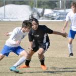 Soldotnas Simon Willets and Nikiskis Jakeup Martin battle for the ball Monday, May 9, 2022, at Nikiski High School in Nikiski, Alaska. (Photo by Jeff Helminiak/Peninsula Clarion)
