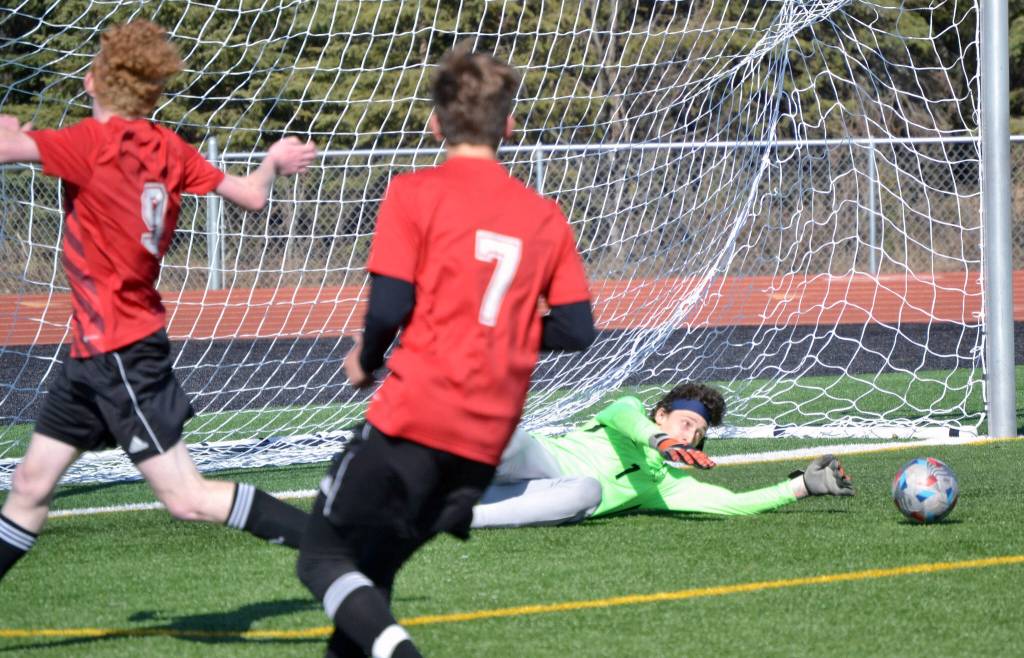 Homer goalie Lucas Story makes a save Tuesday, May 10, 2022, at Ed Hollier Field at Kenai Central High School in Kenai, Alaska. (Photo by Jeff Helminiak/Peninsula Clarion)