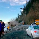 People run from a landslide just outside the downtown area of Seward, Alaska, May 7, 2022. (Josh Gray via AP)