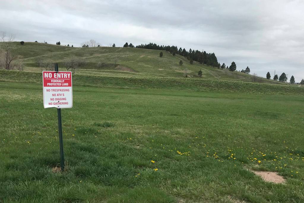 In this photo provided by Randi Oyan, is a hillside near the former Rapid City Indian School, in Rapid City, S.D., on Wednesday, May 11, 2022, that researchers say is the site of unmarked graves of children who died at the school, which operated from 1898 until 1933. A memorial is planned at the site. (AP Photo/Randi Oyan)