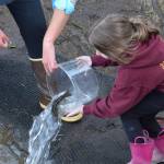 Kamryn Best releases her rainbow trout at the 21st annual Kenai Peninsula Salmon Celebration in Kasilof on Wednesday, May 11, 2022. (Camille Botello/Peninsula Clarion)