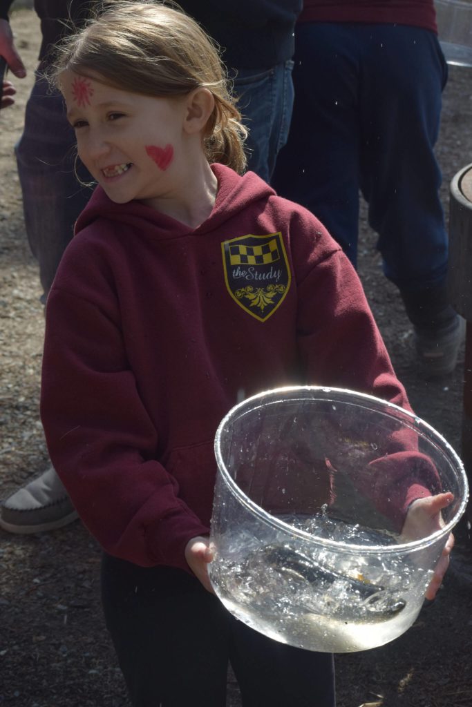 Kamryn Best waits in line before releasing her rainbow trout at the 21st annual Kenai Peninsula Salmon Celebration in Kasilof on Wednesday, May 11, 2022. (Camille Botello/Peninsula Clarion)