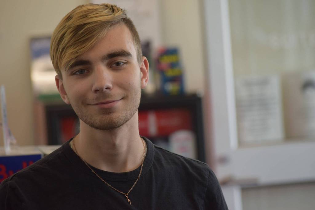 Riley Updike works at My Alaskan Gifts in the Kenai Municipal Airport on Wednesday, May 11, 2022. (Camille Botello/Peninsula Clarion)