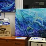 Artwork is displayed as part of "ART Sale 258" at the Cook Inletkeeper Community Action Studio on Thursday, Dec. 9, 2021 in Soldotna, Alaska. (Ashlyn OHara/Peninsula Clarion)