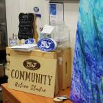 Informatin about Cook Inletkeeper is displayed next to artwork for sale as part of the "ART Sale 258" at the Cook Inletkeeper Community Action Studio on Thursday, Dec. 9, 2021 in Soldotna, Alaska. (Ashlyn OHara/Peninsula Clarion)