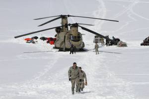 Capt. Corey Wheeler, front, commander of B Company, 1st Battalion, 52nd Aviation Regiment at Fort Wainwright, Alaska, walks away from a Chinook helicopter that landed on the glacier near Denali, April 24, 2016, on the Kahiltna Glacier in Alaska. The U.S. Army helped set up base camp on North Americas tallest mountain. The U.S. Army is poised to revamp its forces in Alaska to better prepare for future cold-weather conflicts, and it is expected to replace the larger, heavily equipped Stryker Brigade there with a more mobile, infantry unit better suited for the frigid fight, according to Army leaders. (AP Photo/Mark Thiessen, File)