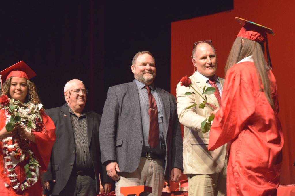 Kenai Peninsula Borough School District Superintendent Clayton Holland (center) helps congratulate Kenai Central High School graduates during a commencement ceremony on Tuesday, May 17, 2022, in Kenai, Alaska. (Ashlyn OHara/Peninsula Clarion)